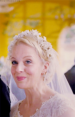 mvrymorstvn:

sherlock meme | seven outfits [4/7] 
↳ mary’s wedding dress

I was really surprised to hear that they didn&rsquo;t tell Amanda Abbington Mary&rsquo;s whole story when they filmed this episode. Really, really surprised. For a few reasons: I didn&rsquo;t realize they didn&rsquo;t read all three scripts before they started shooting (hahahahahaha I should have known they&rsquo;d still be working on the finer details up until the last second, no one&rsquo;s ever as organized as they should be, are they), and also because the decision smacks of a lack of trust. If you wanted Mary as her disguise instead of Mary with her very dark side visible, couldn&rsquo;t you just tell the actor that that&rsquo;s what you want? Amanda Abbington knows what she&rsquo;s doing. She&rsquo;s smart, she&rsquo;s competent. She&rsquo;s an excellent actor. Why not trust her?
Just now, seeing these gifs, I think I get it. Keeping something like that from an actor, potentially alienating a cast member and presumably a friend in this way, they must have wanted something very particular from her. What did they want?
They wanted no suggestion whatsoever of what Mary would do, surely. Not even the slightest hint of a whisper of what she really is. They wanted the truth of her so buried that it doesn&rsquo;t even exist here at all. They didn&rsquo;t want to show Mary pretending to be what John thinks she is; they wanted her to be that Mary. They wanted her eyes clear and unconcerned. No doubts, no concerns, no faltering, no mistakes. Not a hair out of place, not a questionable stray glance.
That&rsquo;s not something normal people can do, entirely subsume themselves, hide their goals and motivations out of every flicker and every movement. No one&rsquo;s that perfect. It would have been a weird thing to ask for, if she&rsquo;d known the truth. It would have seemed terribly fake. She would have wanted to play a woman hiding a terrible secret, naturally. Even just a little bit, when no one was watching. Because that&rsquo;s what she is. But they didn&rsquo;t want that, obviously.
Why not? Why would they want absolutely nothing of what Mary really is to be visible to the viewer, even in retrospect? There&rsquo;s something intensely satisfying in seeing hints of the future in the past, once you know what happens. Why did they disallow us that pleasure?
What we got must be exactly what they wanted. This must be Mary in perfect, perfect control. Her eyes, her face, her emotions: she is perfectly in check. Every move she makes is a decision, and it&rsquo;s always the right one. There is no darkness in her here, though she has plenty of that, as we later learn. She is not haunted, or conflicted, or distressed by her lies and manipulation. She is so perfectly not who she actually is that we have to question everything we see here. This is not Mary (or whatever her real name is). This is what she wants everyone to see and to believe.
She is the consummate actor, the perfect sleeper agent. Sherlock can&rsquo;t see any of her secrets, except a hint that she might lie about a few little things (but who doesn&rsquo;t?). She sets off no red flags. She is lovely and funny and adorable, she is forgiving and understanding, she is unthreatening and unthreatened. She is kind and gentle and intelligent. She befriends everyone, including the viewer, and including Sherlock, as impossible as that has always been for John&rsquo;s girlfriends. But she manages it. She is the perfect manipulator, and no one can see it. She&rsquo;s so good, it&rsquo;s inconceivable. She can become whatever she wants completely and perfectly, and make everyone believe it.
Sherlock must wish he could be this good at pretending to be something he&rsquo;s not. He&rsquo;s pretty good at it, because most people genuinely believe he&rsquo;s a sociopath. But he isn&rsquo;t. Mary is.